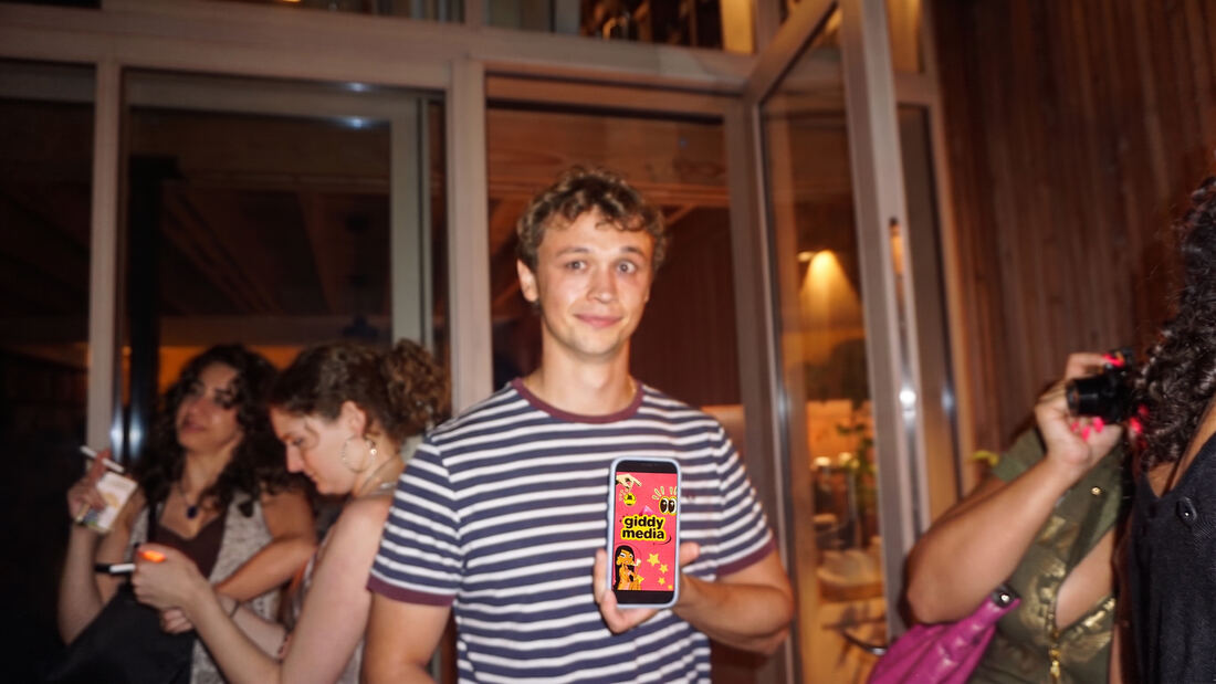 Guest in a striped top with the Giddy screen