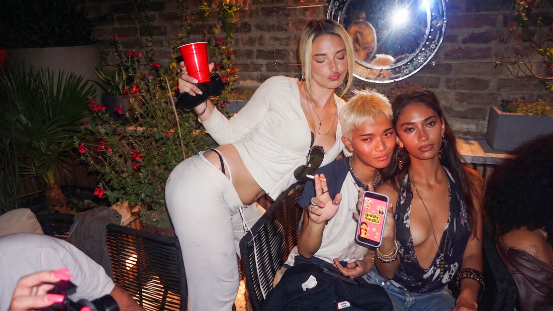 Guests posing outside at night