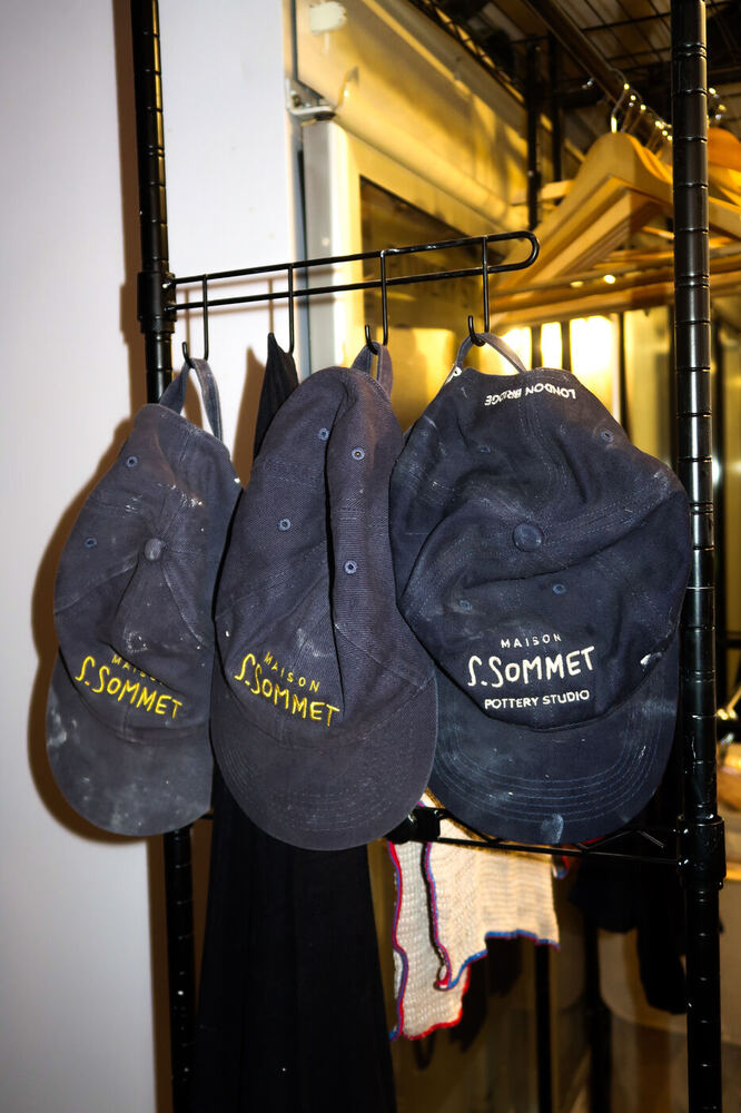 Branded caps hanging in the studio